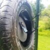 Hang Fast 12 inch AR500 target plate mounted inside a tire using Fail Safe Hangers.