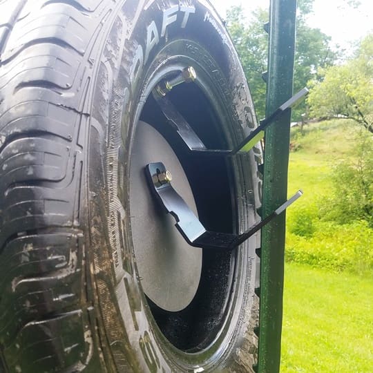Hang Fast 12 inch AR500 target plate mounted inside a tire using Fail Safe Hangers.
