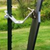 A black metal gate latch with a handle and a lock mechanism