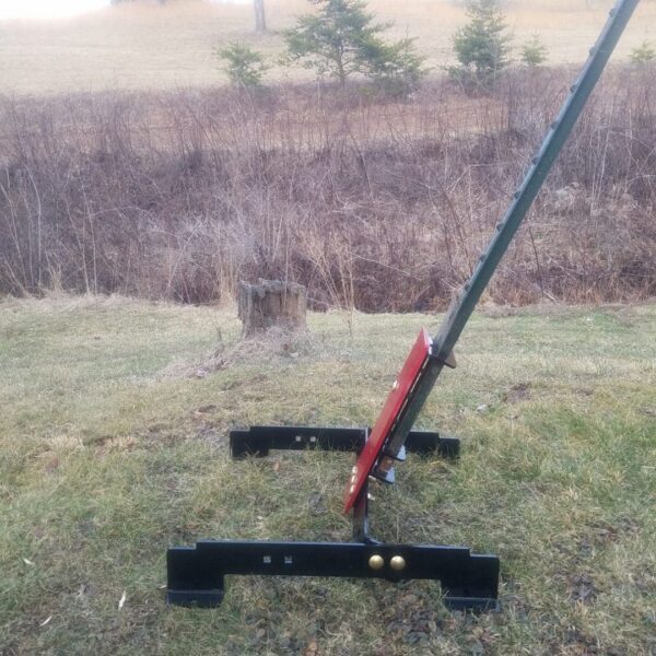 T Post stand 3 Hang Fast Targets Black metal A frame yard stand on grass with a red bracket attached to a long green pole outdoors in a field