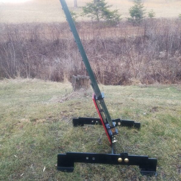 T Post stand 4 Hang Fast Targets Disassembled trailer jack and base resting on grass outdoors with a long green arm attached to a red mounting plate