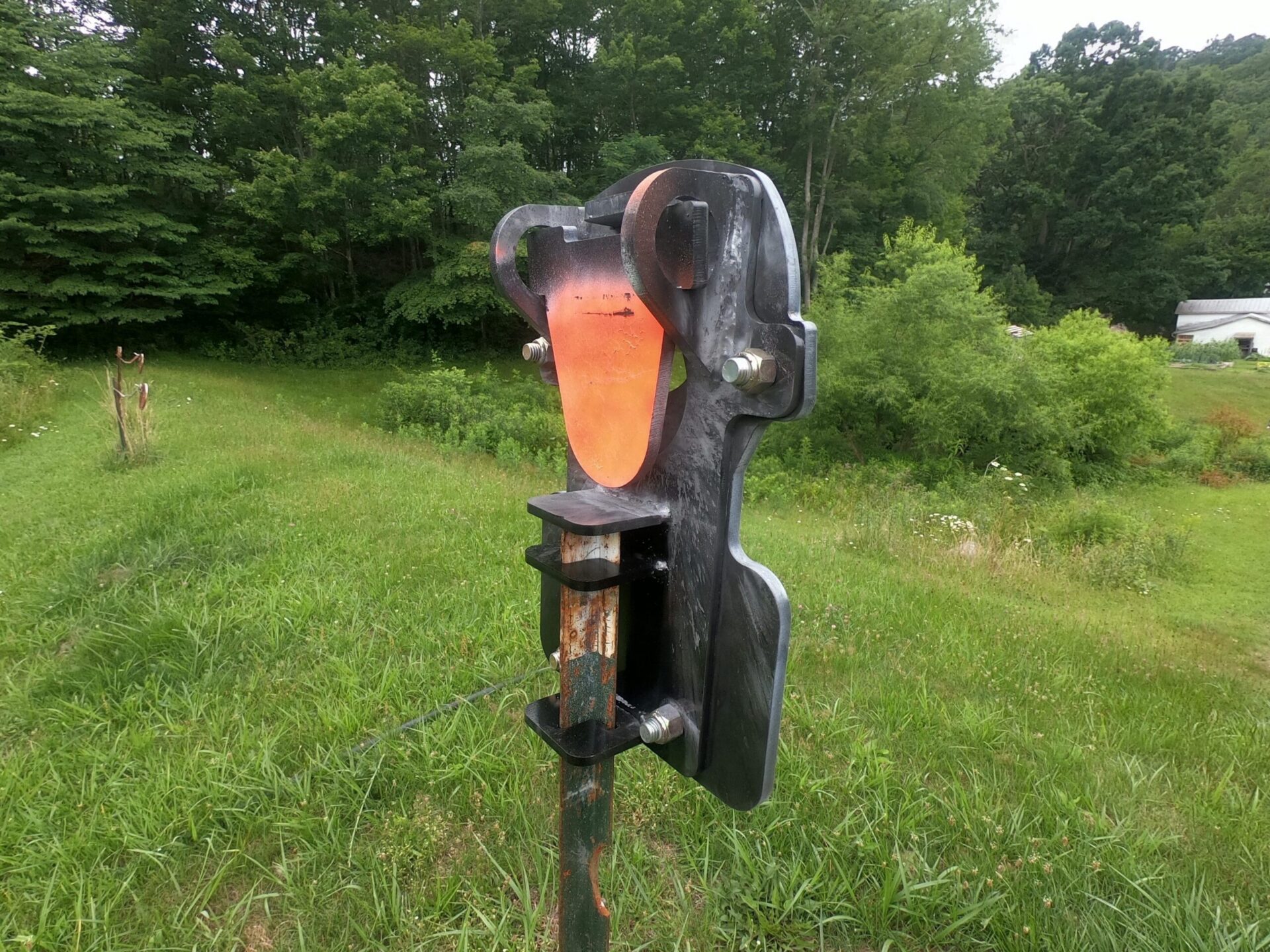 Rear view of Hang Fast Red Mist T-Post target showing flapper plate and mounting hardware.