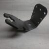 Metal mounting bracket with multiple bolt holes and a forked clamping end on a grid background