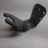 Metal mounting bracket with multiple bolt holes and a forked clamping end, on a grid background